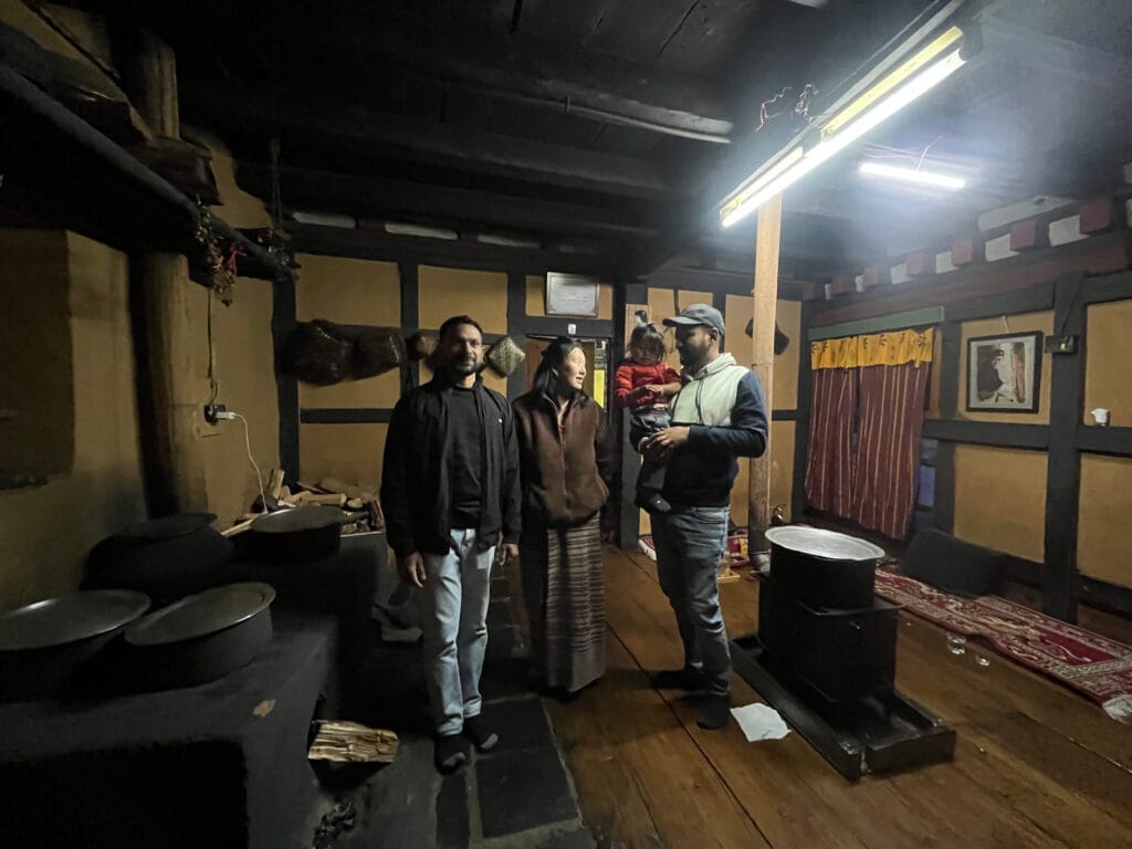A bhutanese family sharing farmhouse Dinner Experience with SOL Guest Piyush while travelling to Bhutan